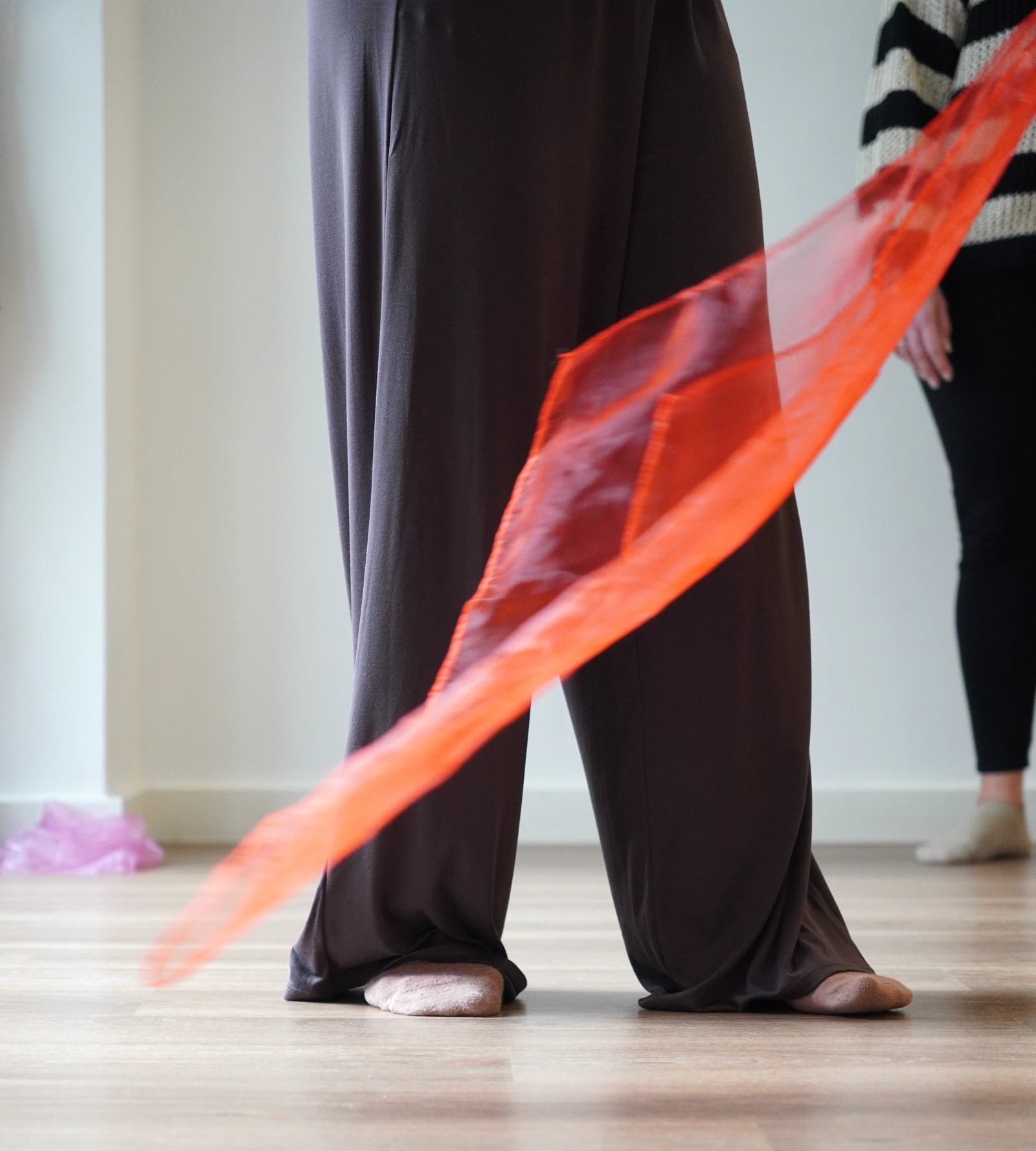 A colourful scarf floating through the air during a movement session